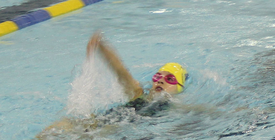 KSC swimmer Carly Nelson, 9, competes Saturday morning. -Photo by McKibben Jackinsky, Homer News