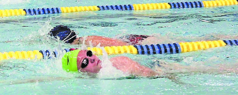 Jenna Fabich, front, and Lauren Kuhns, back, swim 1,000 yards at Kate Kuhns Aquatic Center during the first leg of the triathlon.