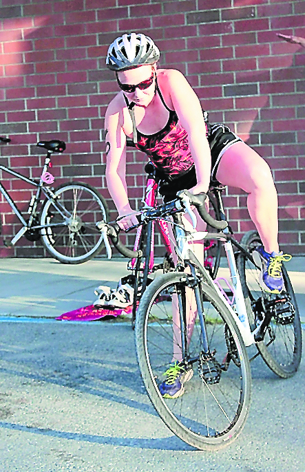Lila Johnson begins the bicycle leg of the triathlon.