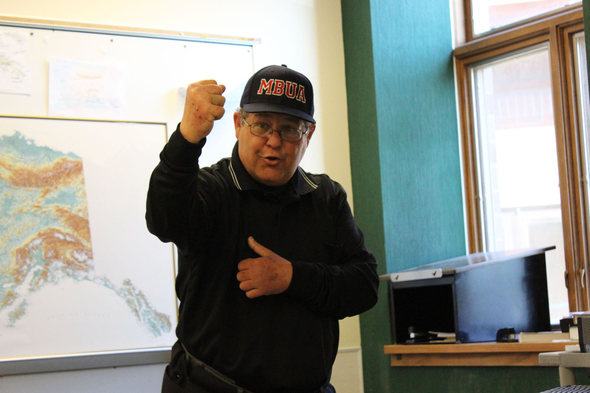 Don Felton demonstrates the “out” sign during an umpire clinic earlier this month.-McKibben Jackinsky, Homer News