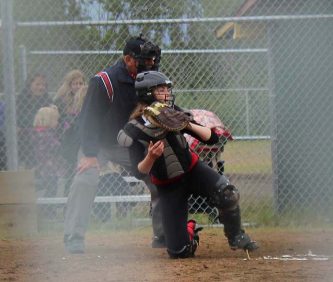Jay Cohen umpires from home plate during the Mariners’ softball game against Kenai.-McKibben Jackinsky, Homer News