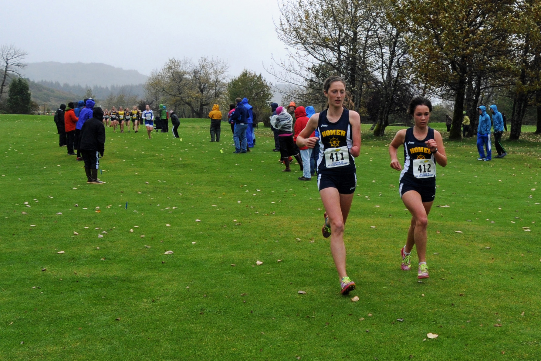 Homer runners Megan Pitzman, 411, and Molly Mitchell, 412, hold the lead in regions cross-country varsity girls competition in Kodiak Sept. 27. Pitzman was the first to cross the finish line, with Mitchell in second.