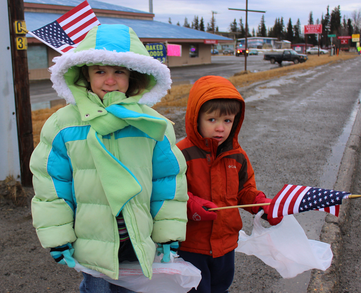 Bundled up against a chilly wind, Morgan and Quinn Kelly have bags in hand to collect candy during last Saturday morning’s Anchor Point Snow Rondi parade. -Photo by McKibben Jackinsky, Homer News