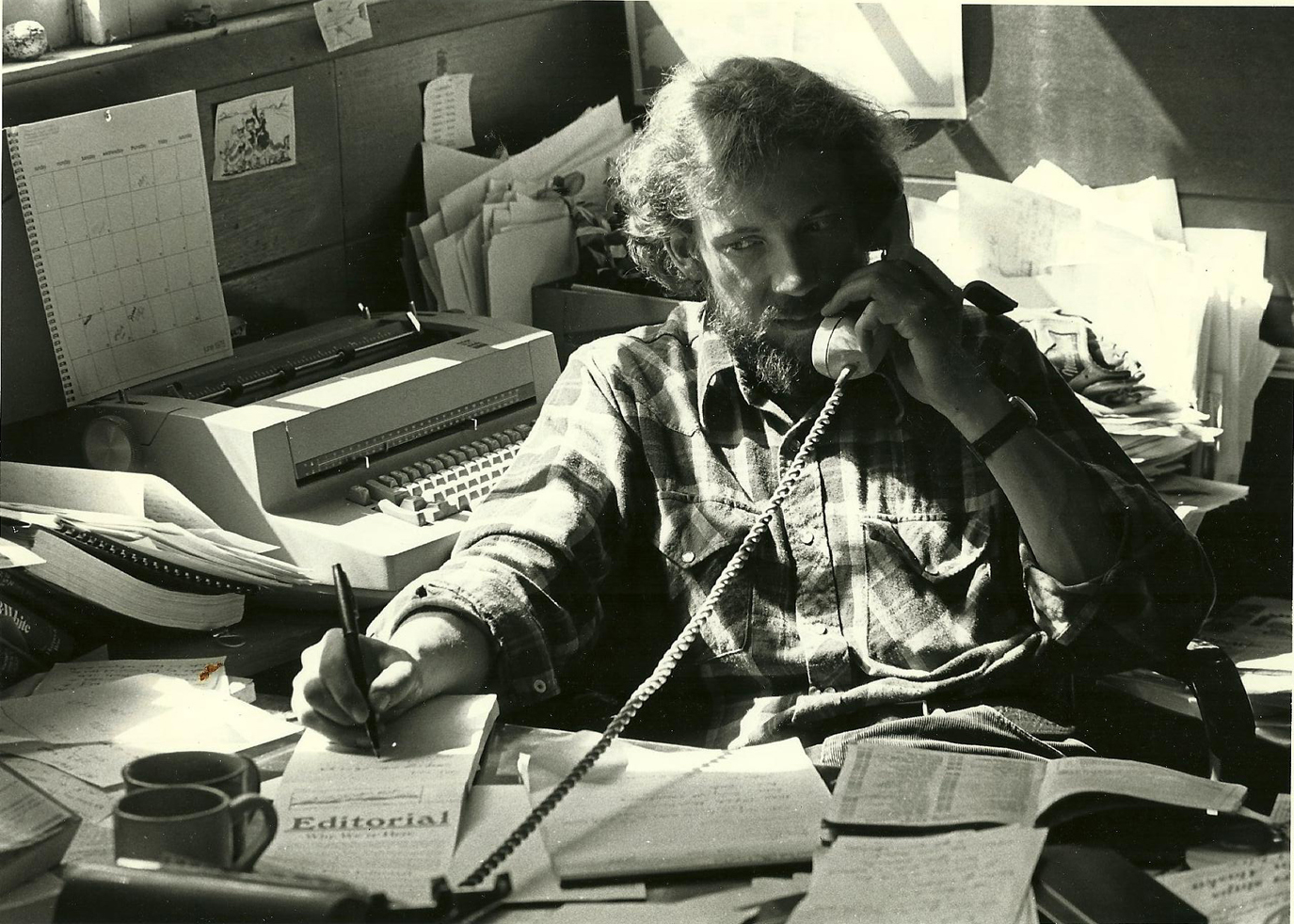 Homer News Managing Editor Tom Kizzia fields a phone call in 1978, when the Homer News was located in the building that now houses Cafe Cups.-Photo provided