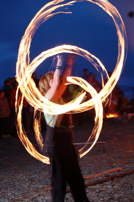 A fire dancer does poi, or fire spinning, during the 2010 Burning Basket celebration. Fire spinning is one of the workshops that will be done at the Hungry Hat Circus on Saturday at Bishop’s Beach.-Photo by Michael Armstrong, Homer News
