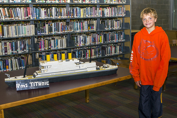 Rio Shemet Pitcher stands next to his LEGO sculpture of the RMS Titanic.-Photo by Don Pitcher