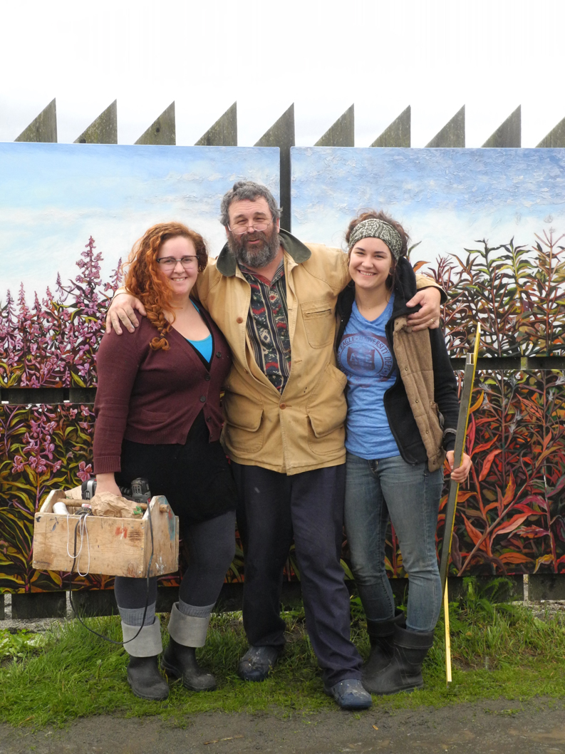 Dan Coe, center, stands with the assistants who helped him paint the fireweed mural, Karen Simpson, left, and daughter Rachel Coe, right. -Photo by Michael Armstrong, Homer News