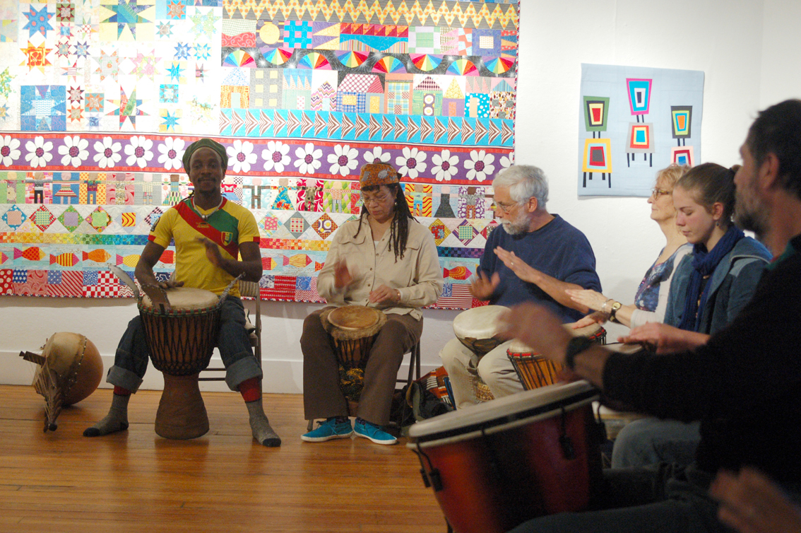 Soriba Fofana, left, demonstrates a drumming pattern on his djembe at a workshop Monday night at Bunnell.-Photo by Michael Armstrong, Homer News