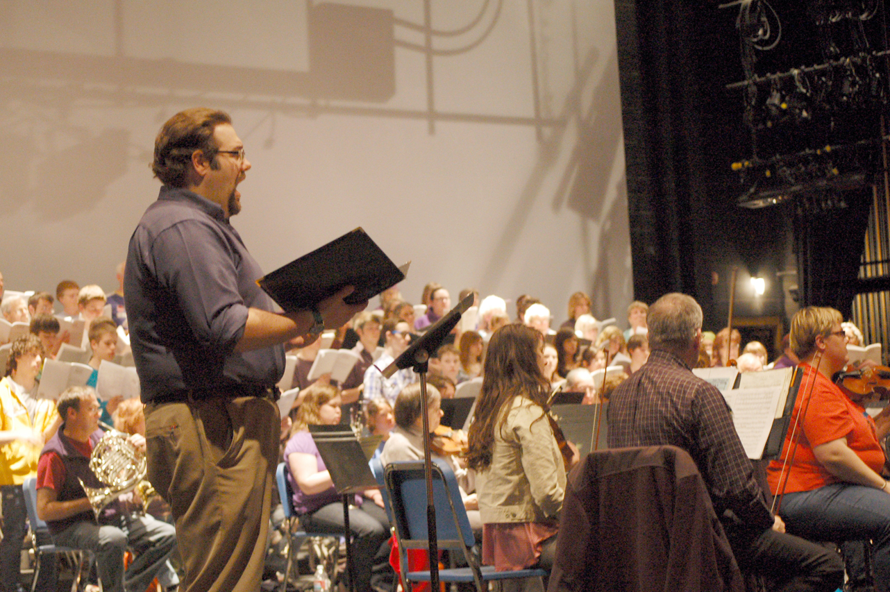 Homer High School Choir Director Kyle Schneider sings a solo during rehearsals on Sunday.-Photo by Michael Armstrong, Homer News