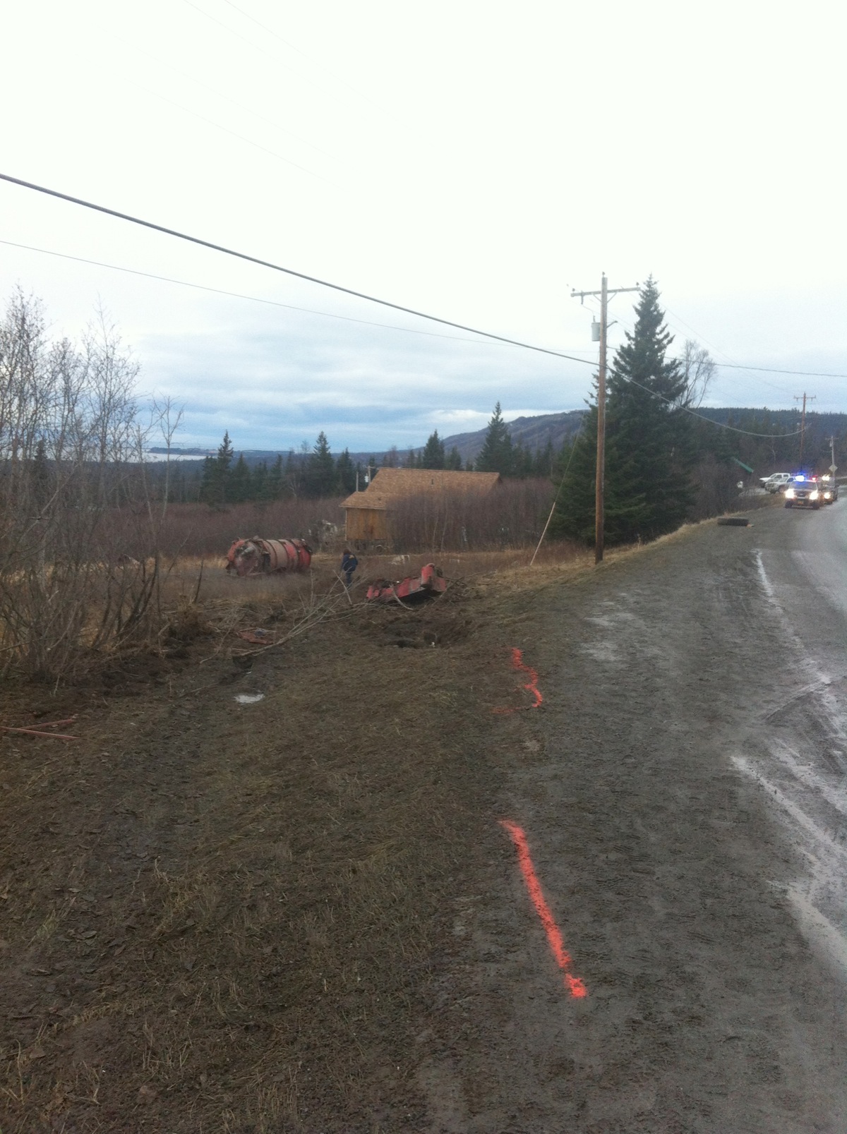 In this photo provided by Alaska State Troopers of a fatal truck crash today, drilling mud tanks can be seen in a field on the south side of the road near Mile 9.5 East End Road.-Photo provided, Alaska State Troopers