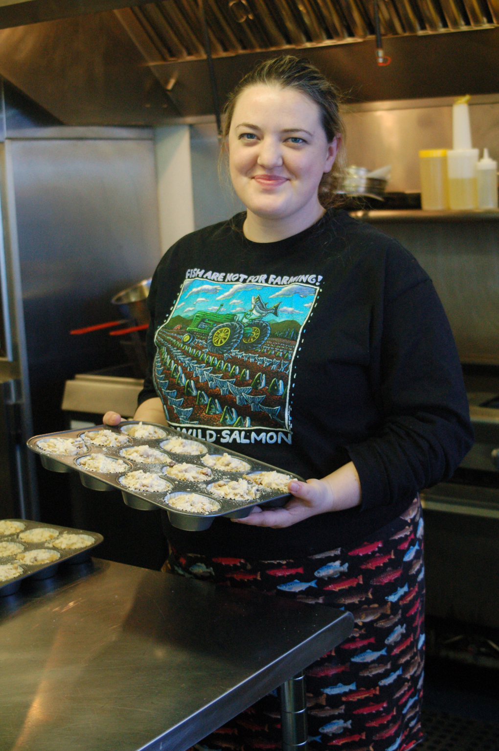 Mandy Dixon holds a tray of muffins ready to go into the oven in the kitchen of La Baliene. The cafe opened May 10 on the Homer Spit and is across from the Seafarers Memorial and near the steel grid at the harbor.-Photo by Michael Armstrong, Homer News