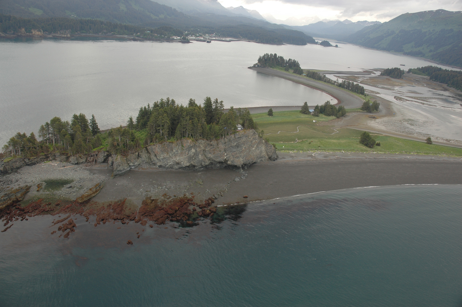 This view of Seldovia Bay, looking from Point Naskowhak toward Seldovia in the background, is part of Alaska ShoreZone, a catalog of high-resolution still and video images that provide bird’s-eye views of Alaska beaches. The photo was taken from a helicopter during June 2009, at low tide.-Image courtesy of Alaska ShoreZone.