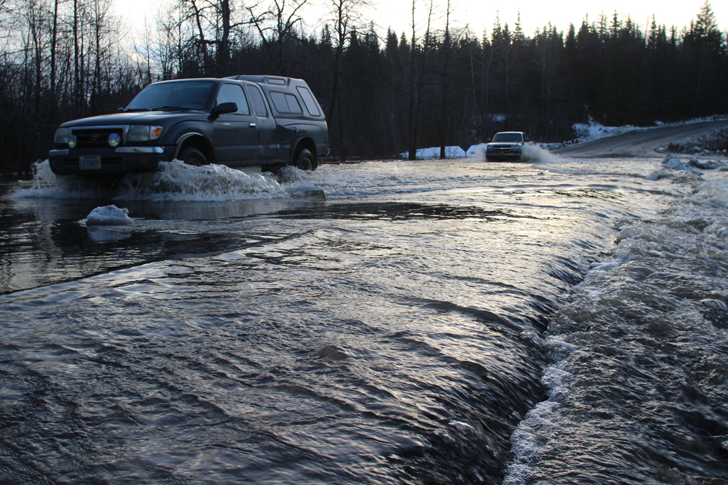 Trucks go through flooding on the Old Sterling Highway near the Anchor River bridge on Dec. 30.-photo by Mike Lettis
