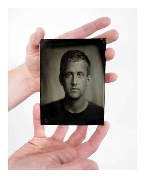 Adam Ottavi holds a self-portrait he did using the tintype process.-Photo Provided