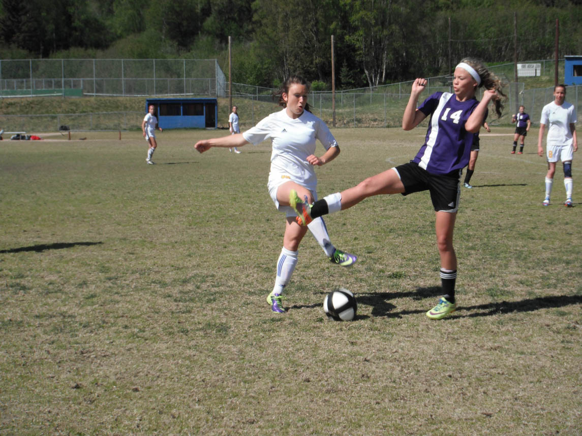 Mariner Aspen Daigle, left, fights for possession of the ball against Seward player on Friday.-Photo by Shannon Reid