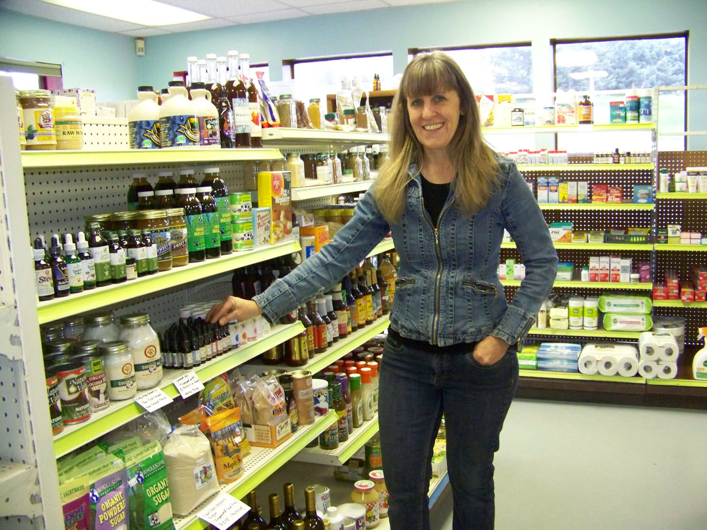 Tara Kain points out some of the inventory of her store, Anchor Point Natural Foods, now located at 345 Sterling Highway, Suite 105, next to Enstar’s office.-Photo by McKibben Jackinsky, Homer News