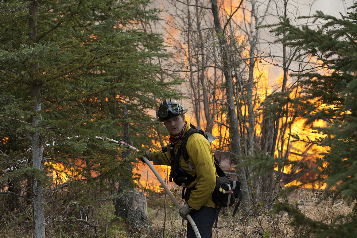 Central Emergency Services firefighter Spencer Mclean works to contain a portion of the nearly 183,000-acre Funny River Horse Trail wildfire near Soldotna’s Funny River neighborhood on Sunday.-Photo by  Rashah McChesney,  Morris News Service - Alaska