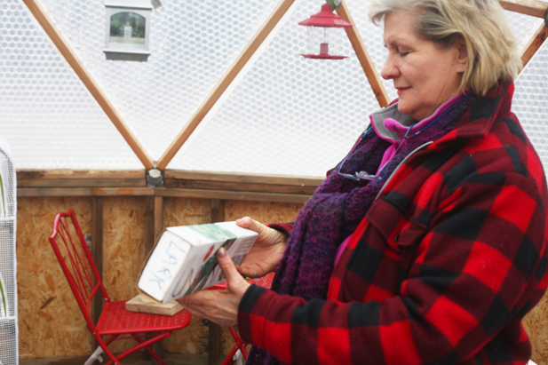 Lark Ticen holds an automatic vent opener, which she will eventually install in the roof of her Arctic Dome.-Photo by Kelly Sullivan, Morris News Service - Alaska