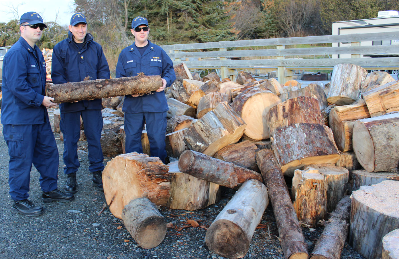 A little teamwork from David Simonds, left, Aleksander Kay and Jonathan Alexander of the U.S. Coast Guard Marine Safety Detachment in Homer are getting the job done: wood chopped for firewood and being sold by the truckload to benefit Share the Spirit. Other MSD personnel helping with the project are Lt. William Albright, Justin Harrison and Keith McKinney. -Photo by McKibben Jackinsky, Homer News