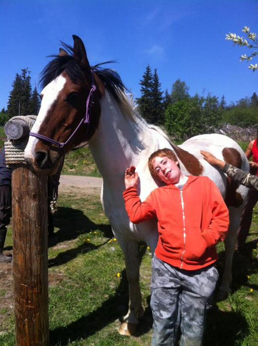 Kody Cardwell visits with one of the farm horses during Wild, Sustainable Summer, a program between Homer Wilderness Leaders and Steller Gardens.-Photo Provided