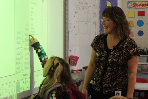 Madilyn Illg marks herself as present in Paul Banks teacher Wendy Todd’s kindergarten classroom.
