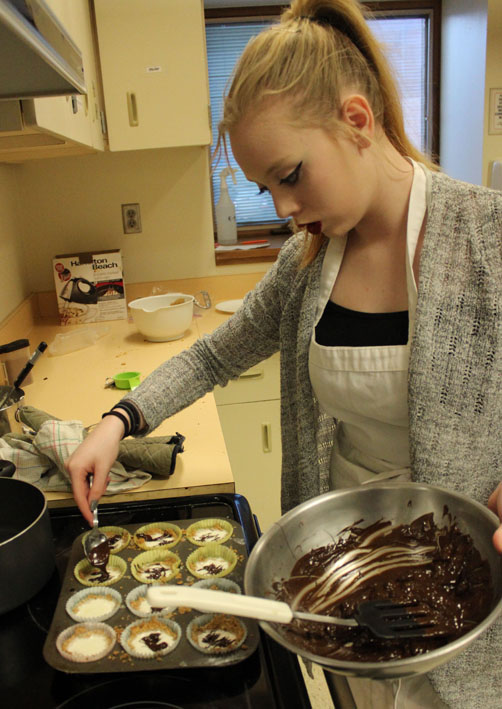 Hanna Marsh,  puts a chocolate drizzle on dessert.-Photo by McKibben Jackinsky, Homer News