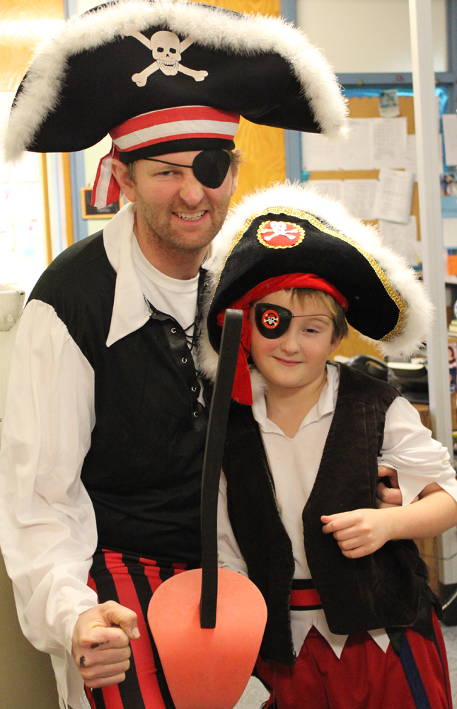Paul Banks Elementary School Principal takes on the persona of Redbeard the Pirate, with a younger version played by his son, Einar, during the school’s readathon kick-off assembly on Monday.