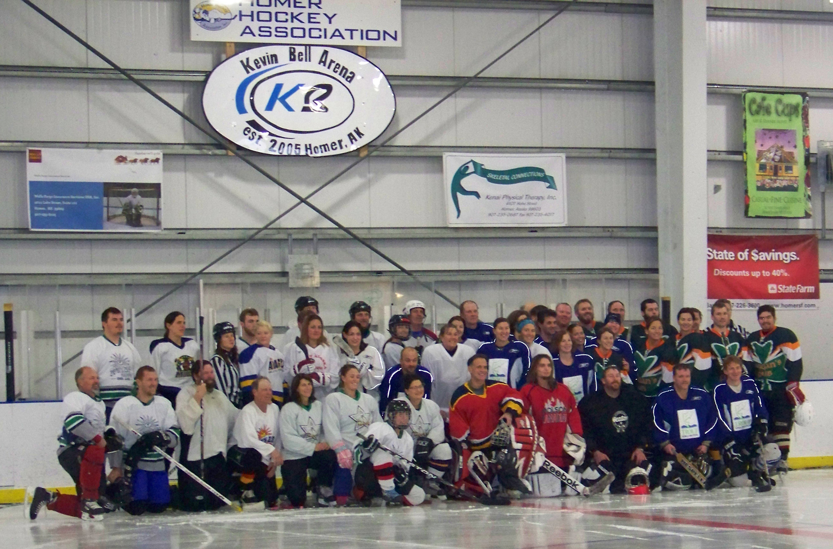 Four teams participating in the Homer Coed Adult Hockey Jamboree take a time-out for a group photo.-Photo by McKibben Jackinsky, Homer News