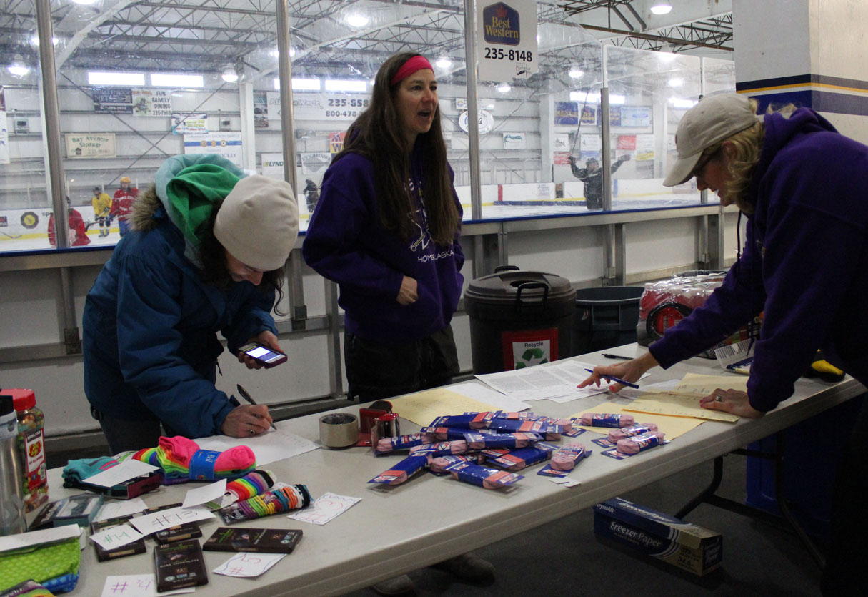 Kellie Bolin, Karen Weston and Terri Larson help with sign-ups at Sunday’s “Girls’ Hockey Weekend” at the Kevin Bell Arena.-Photo by McKibben Jackinsky, Homer News