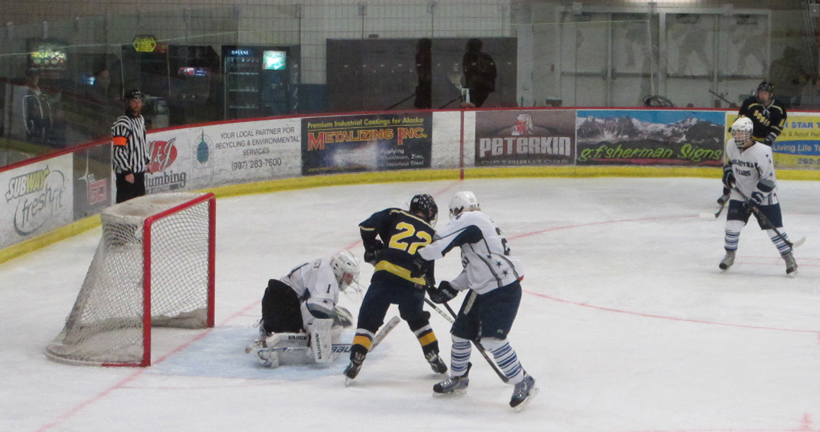 Mariner Garrett Butcher follows the shot to the net during Tuesday’s game against Soldotna.          -Photo by Wendy Wayne