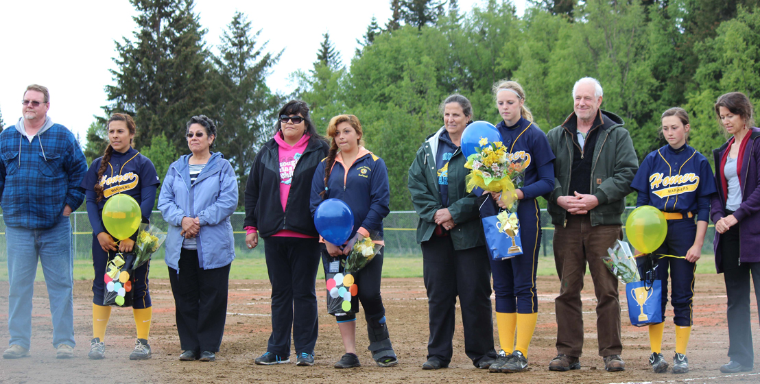 Honored at the Mariners’ Monday game are, from left, Shyanna Parr and her parents Bill and Victoria, Jordyn Haye and her mom Carrie, Hailey Hughes and her mom Robbie Coffey and dad Steve Hughes, and Brenna Evearts and her mom Fran. -Photo by McKibben Jackinsky, Homer News