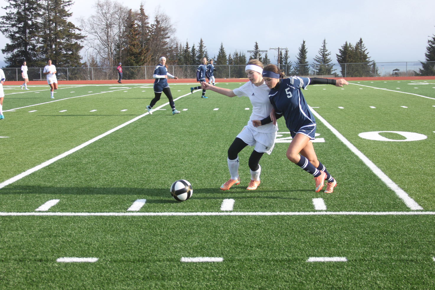 Homer High School freshman Andie Sonnen works to gain ground against a SoHi midfielder during the Mariner-hosted game on Tuesday.