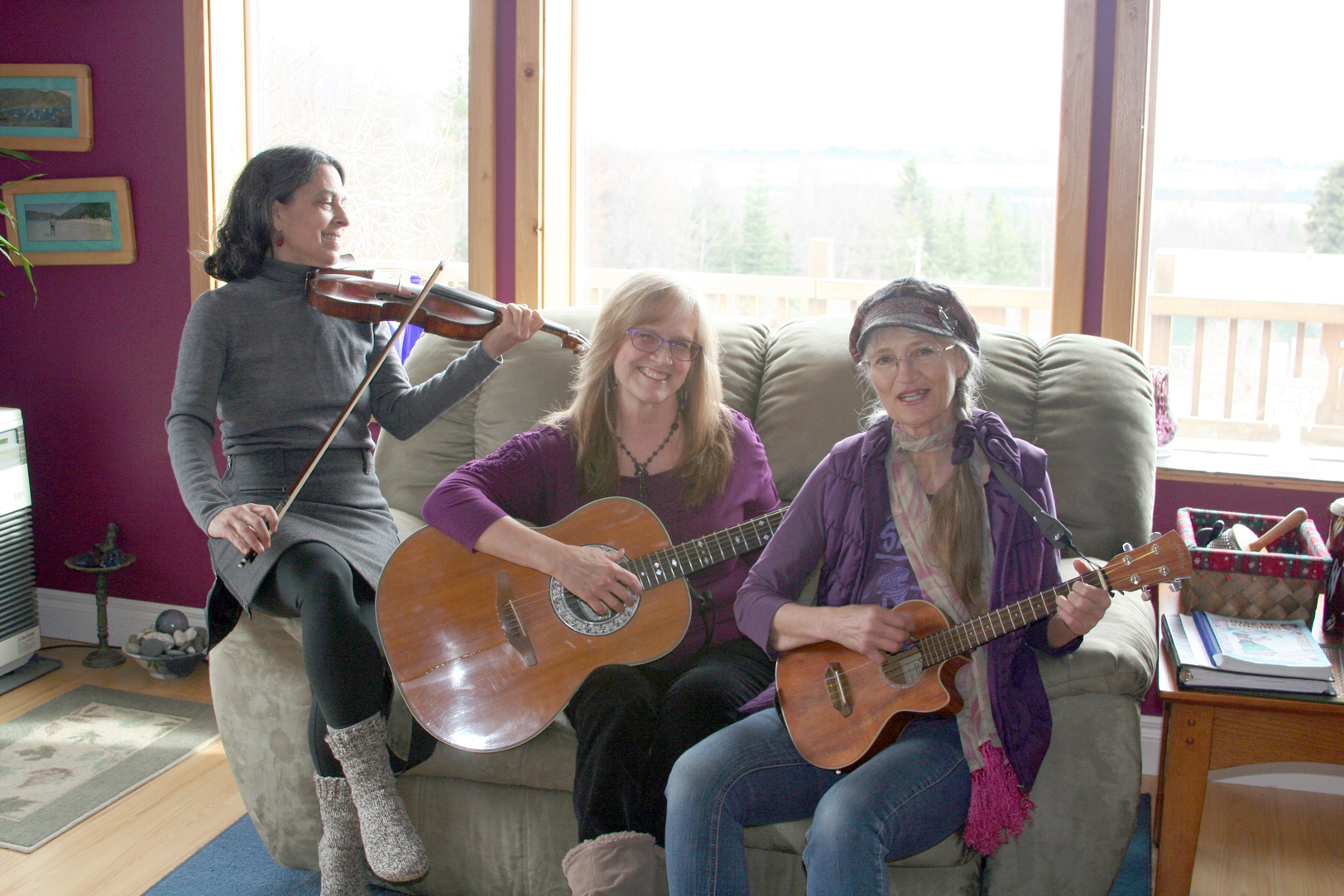 From left to right, Lindianne Sarno, Sharon Friesen Schulz and Sunrise Kilcher-Sjoeberg rehearse recently Schulz’s song, “Sweet Little Bird,” for the 11th annual “On the Wing: Celebrating Birds and Spring with Poetry and Song” concert at 7 p.m. today at the Homer Theatre. -Photo Provided