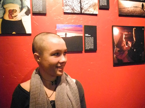 Molly Mitchell stands next to her photograph, “Gratitude" at the First Friday opening of the PhotoVoice exhibit at K-Bay Caffe.                          -Photo by Michael Armstrong, Homer News