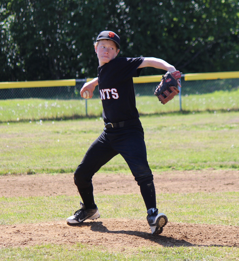 Mose Hayes winds up a pitch during Saturday’s game against a Kenai team.-Photo by McKibben Jackinsky