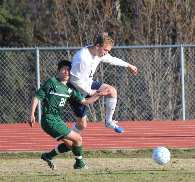 Mariner Drew Brown gets the jump — literally — on a member of the Colony Knights soccer team as the two scramble for control of the ball during Friday’s game.