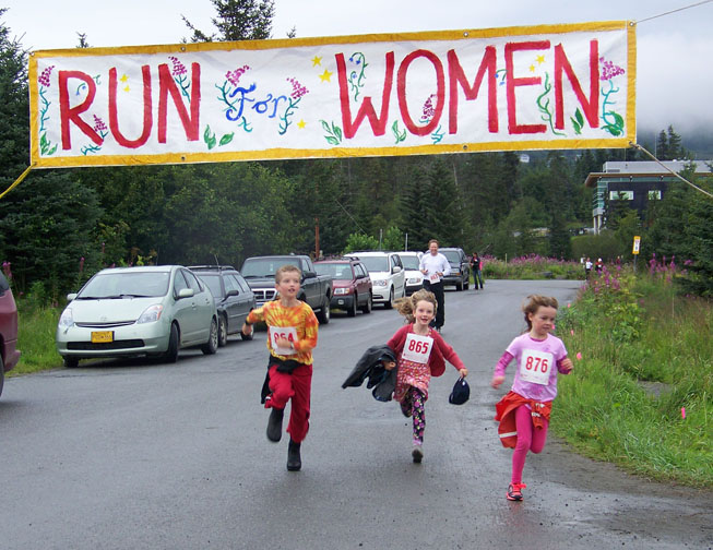Seamus McDonough, 8, Bea McDonough and Eryn Field, 8, dash across the finish line at Sunday’s Breast Cancer Run.-Photo by McKibben Jackinsky,  Homer News