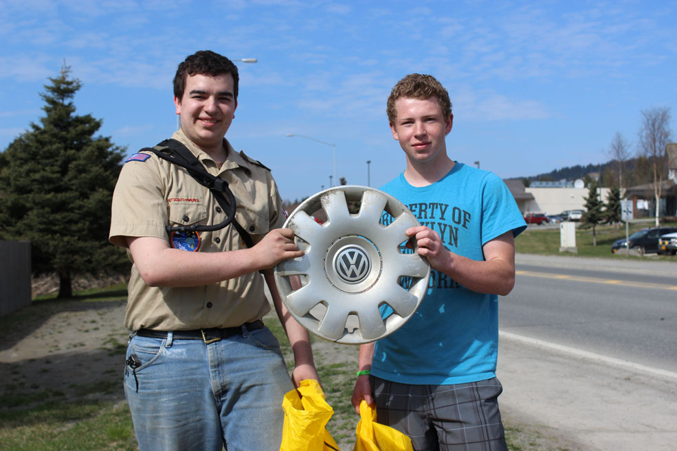 A VW hubcap is one item collected during Cleanup Day that Marshall Fuller, left, and Andrew Anderson of Boy Scout Troop 365 decided not to throw away.-Photo by McKibben Jackinsky, Homer News