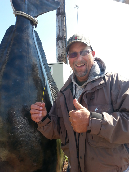 Don Barney is all smiles after catching a tagged halibut worth $250.-Photo provided