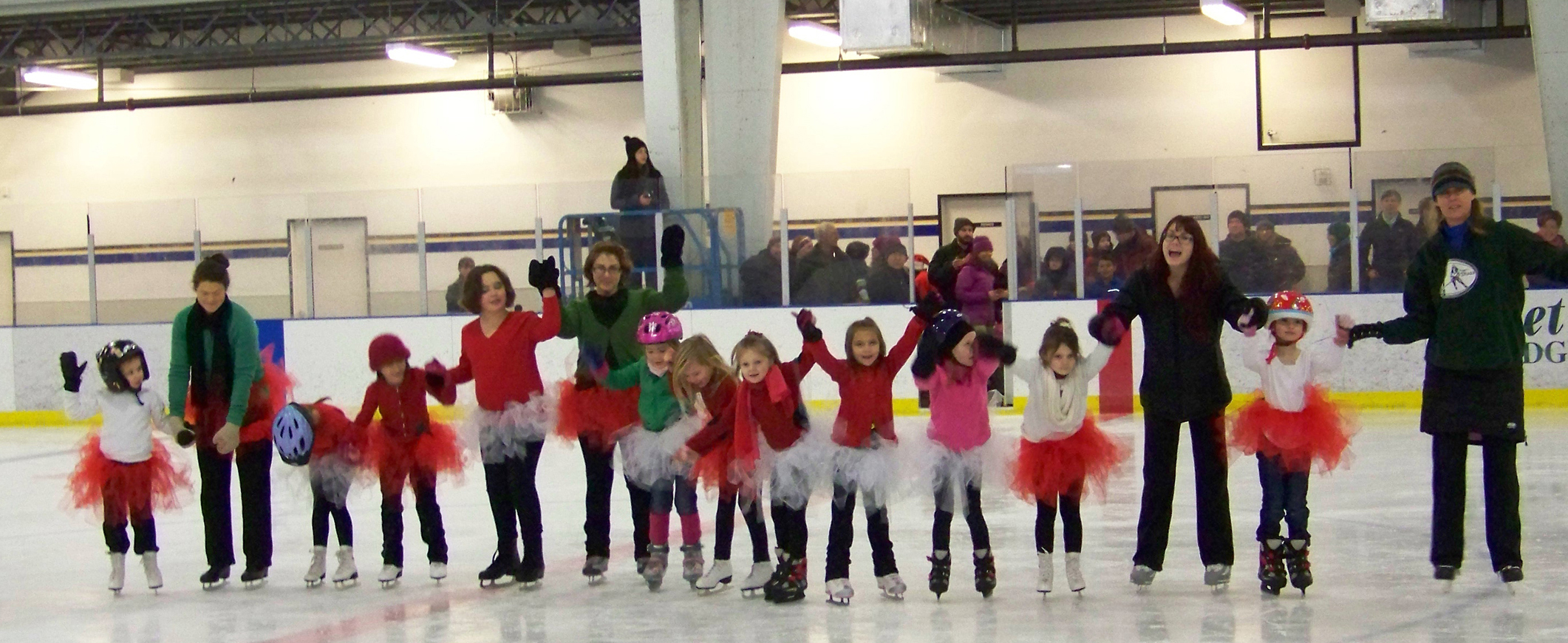 Figure skaters take a bow before cheering fans during a December 2013 event at the Kevin Bell Arena. From left: Madilyn Illg, Cara Clemens, Sylvia Clemens, Thea James, Tianah Cavanaugh, Rhonda Velsko, Sabre Wilmeth, Keagan Niebuhr, Natalia Sherwood, Natalie Farren, Courtney Galloway, Evelyn Sherwood, coach: Natalie Betley, Mia Hemphill, assistant: Priscilla Andrade.-Photo by McKibben Jackinsky, Homer News