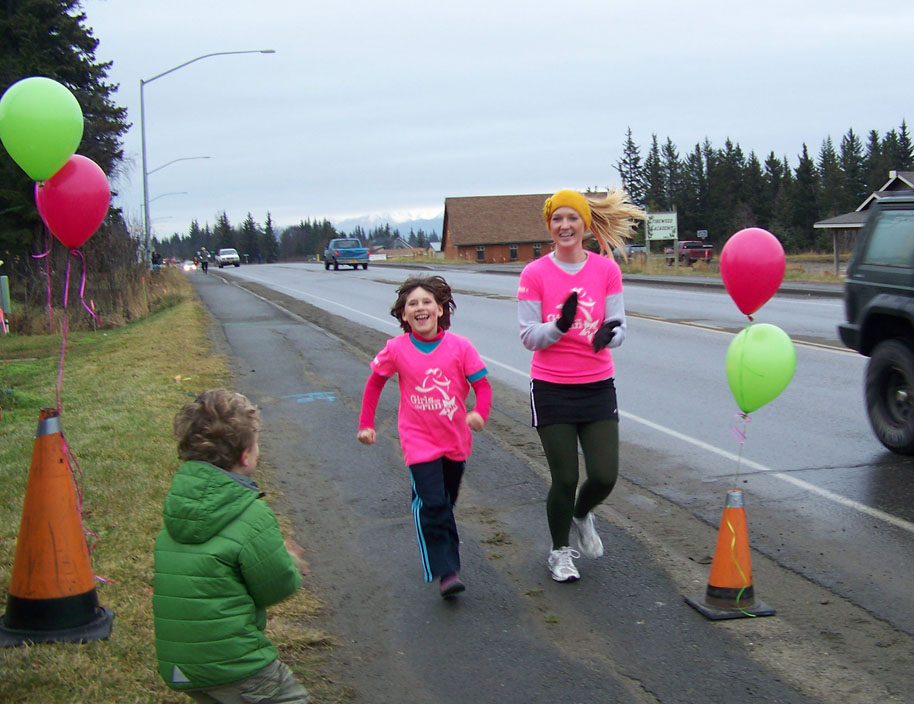Nicole Vendenaal completes Saturday’s 5K Girls on the Run with her running buddy, Britni Johnson. The program for  girls in grades three-five aims at educating and inspiring them for a lifetime of self-respect and healthy living.-Photos by McKibben Jackinsky, Homer News