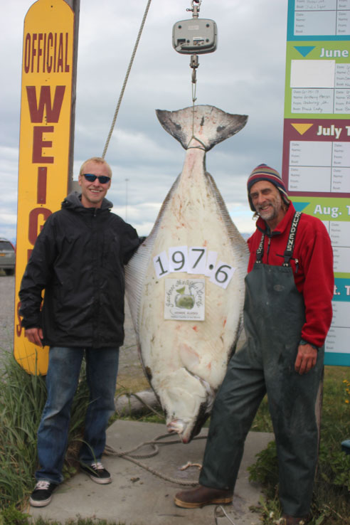 Christopher Johnson, left, with Capt. Scott Glosser, is the current leader in the 2013 Homer Jackpot Halibut Derby. -Photo provided
