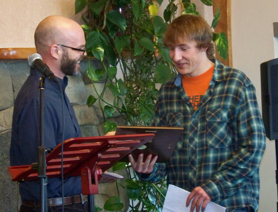 Homer High School teacher Sean Campbell, left, presents Ethan Kizzia with the Youth! Learner award.