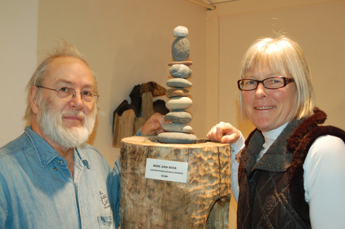 Dan Fischer, left, and Deb Lowney, right stand by one of their sculptures.