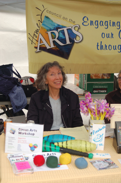 Christa Collier staffs the Homer Council on the Arts booth.-Photo by Michael Armstrong, Homer News