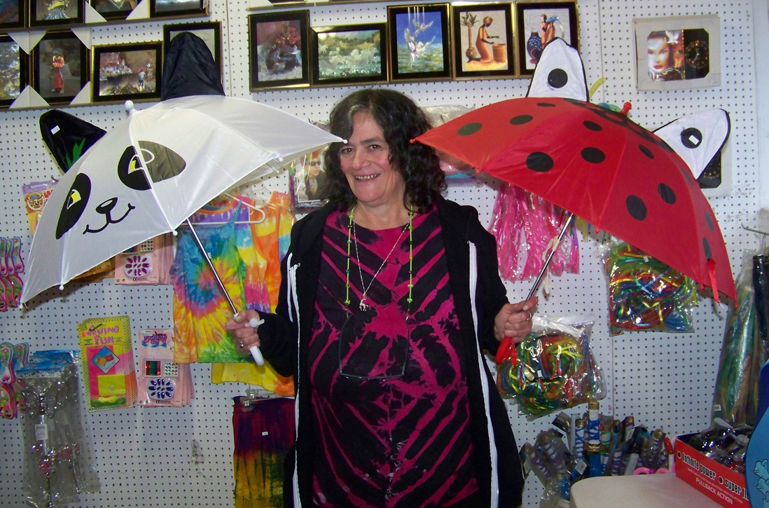Deb Greeson of Alaska Crystal Cache did a booming business selling umbrellas at the Kenai Peninsula Fair on Friday.-Photo by McKibben Jackinsky, Homer News