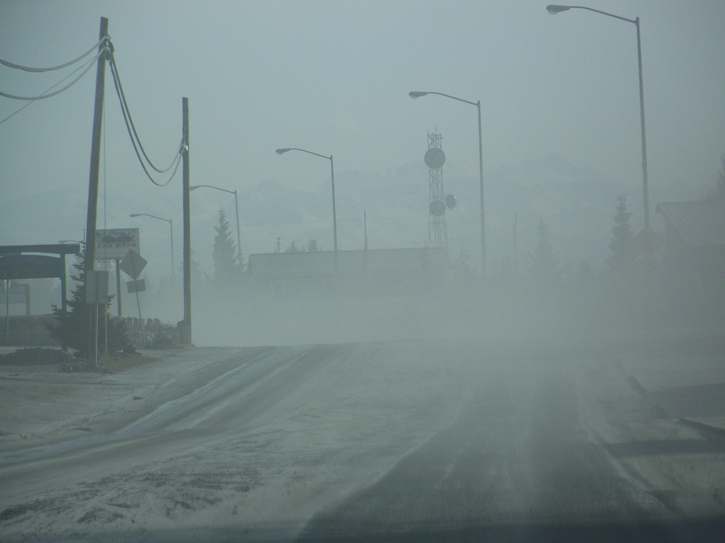 Ashfall during the 2009 eruption of Redoubt Volcano reduces visibility along Homer’s Pioneer Avenue.-Photo by McKibben Jackinsky, Homer News