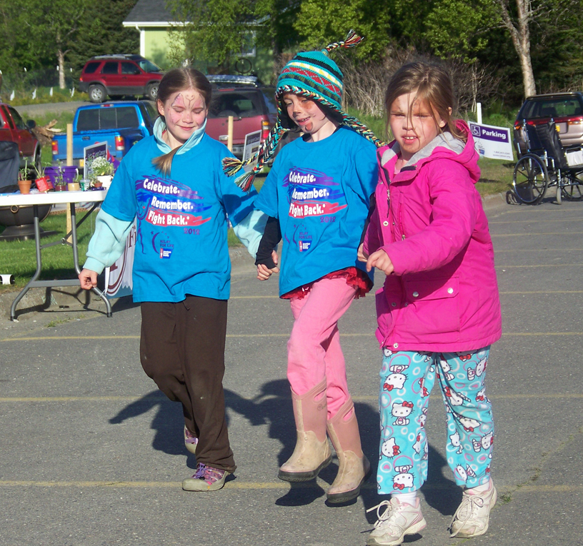 Team Puppies co-captains, from left, Hannah Vance, Neviya Reed and Sophia Park compete in team events during Relay For Life of Homer last year.-Homer News file photo