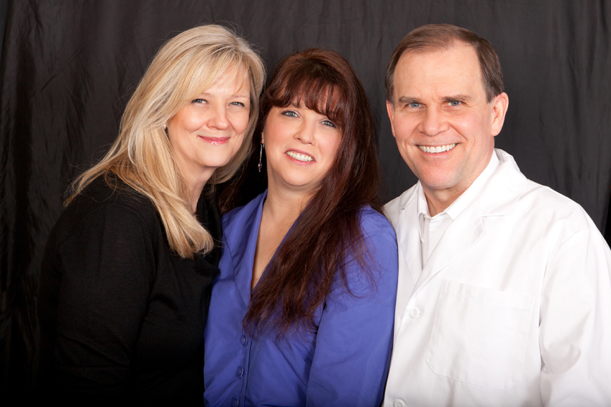 Paula Lee, center, poses with Dr. David Nelson and his wife, Luanne. The Nelsons donated dental work to Lee after her application for the Give Back a Smile program was approved.-Photo provided