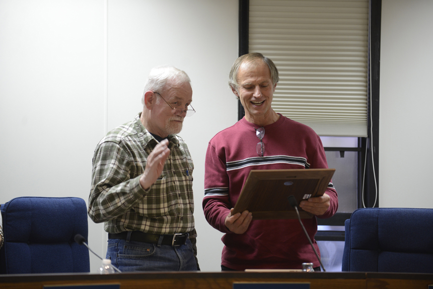 Kenai Peninsula Borough Assembly member Bill Smith of Homer accepts a plaque from member Brent Johnson during Smith’s last meeting on Tuesday in Soldotna.-Photo by Rashah McChesney/Peninsula Clarion
